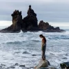 a lady enjoying the peace at the sea shore