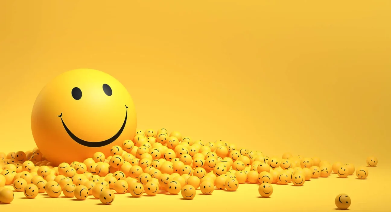 the happiness smiley balls in yellow color is falling on the floor